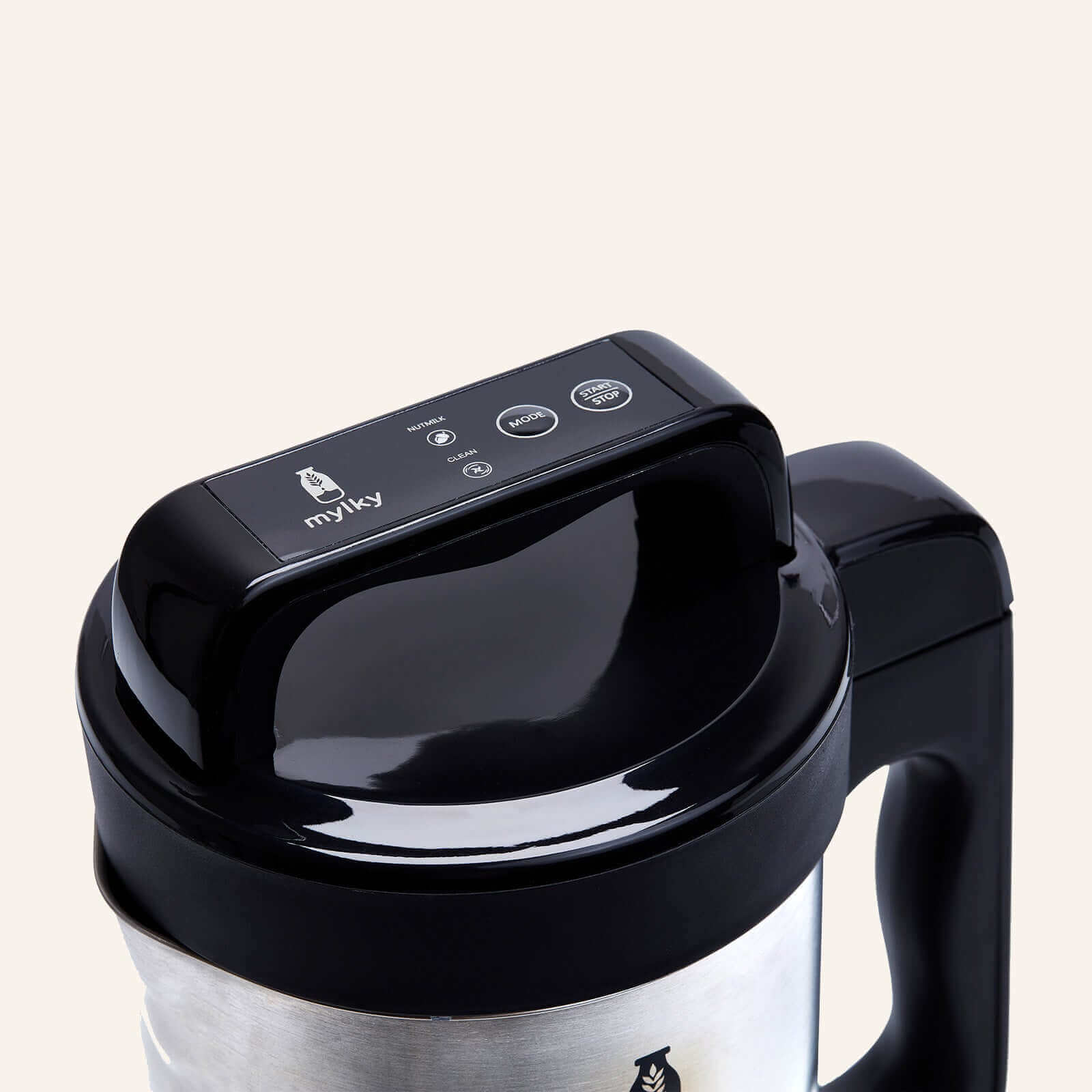 Close-up of Mylky plant-based milk maker with a sleek black lid and stainless steel body