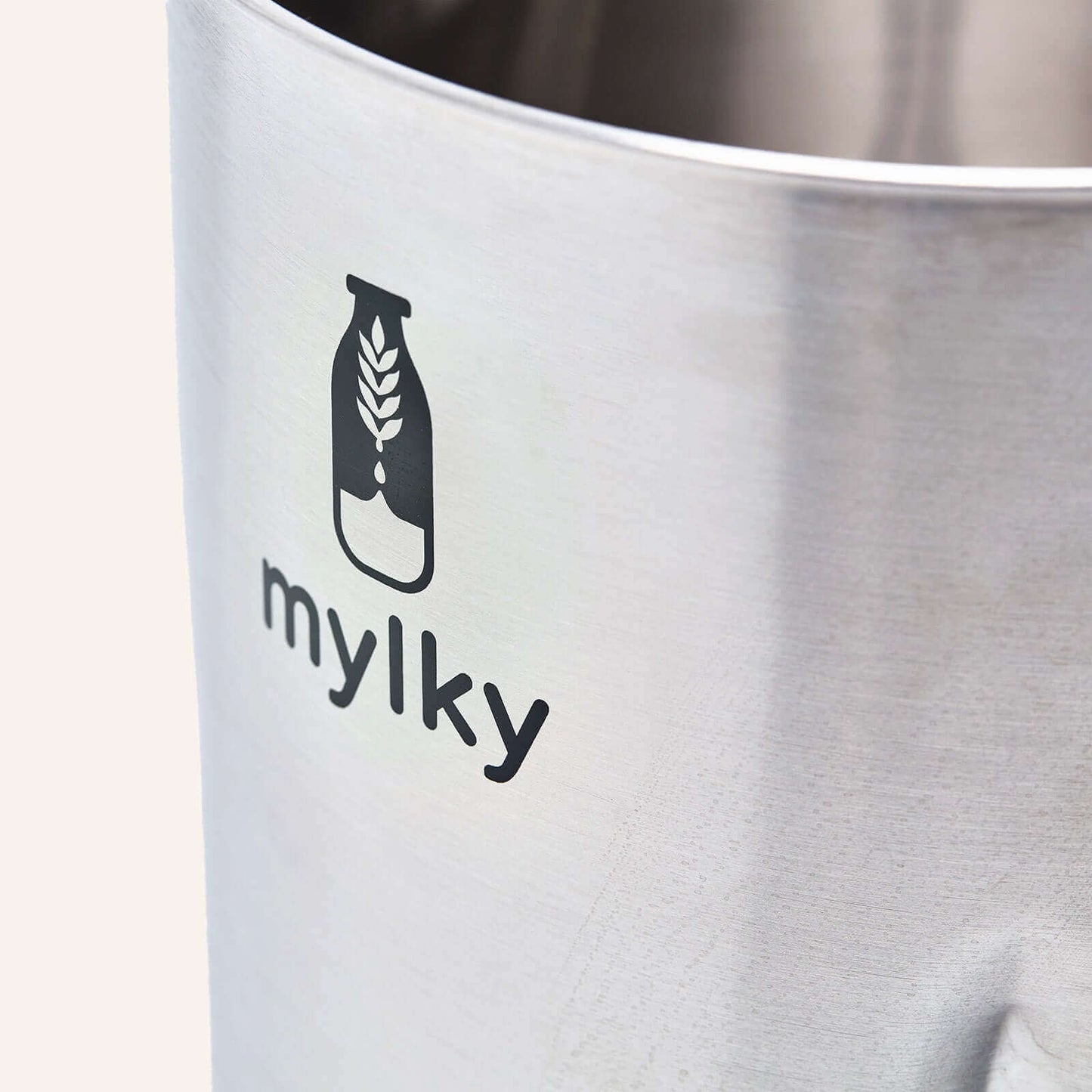 Close-up of Mylky stainless steel jug with logo